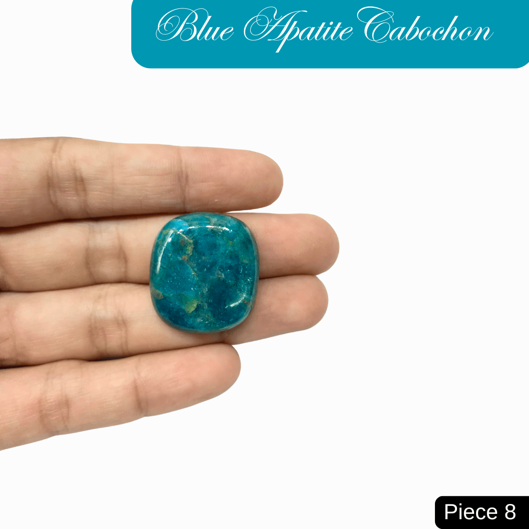Hand holding vibrant blue apatite cabochon gemstone, showcasing its deep ocean blue to turquoise shades and clarity-enhancing properties.