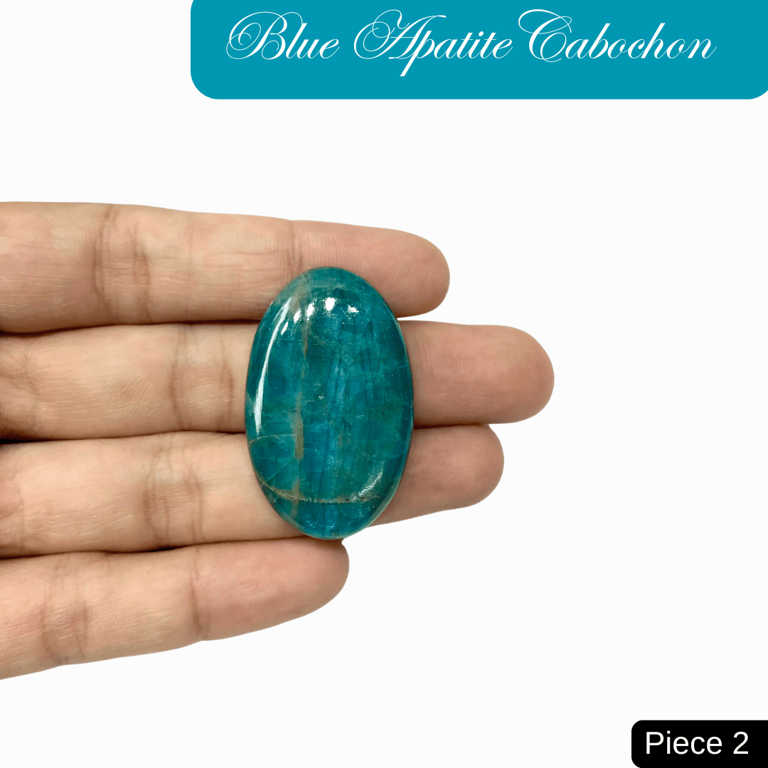 Hand holding a blue apatite cabochon, showcasing its vibrant ocean blue color and translucent quality, ideal for jewelry making.