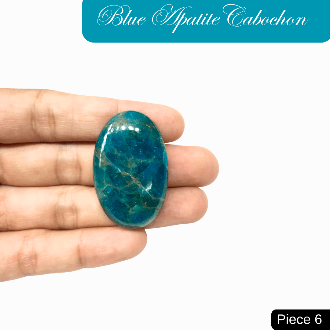 Hand holding a blue apatite cabochon gemstone, showcasing its vibrant hues and translucent quality, ideal for mental clarity and self-expression.