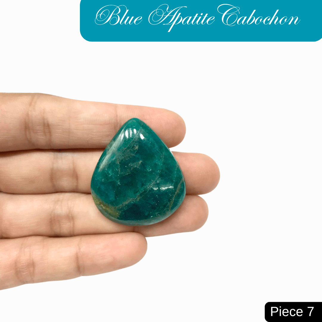 Hand holding a vibrant blue apatite cabochon with deep ocean hues, piece 7, known for mental clarity and personal growth benefits.