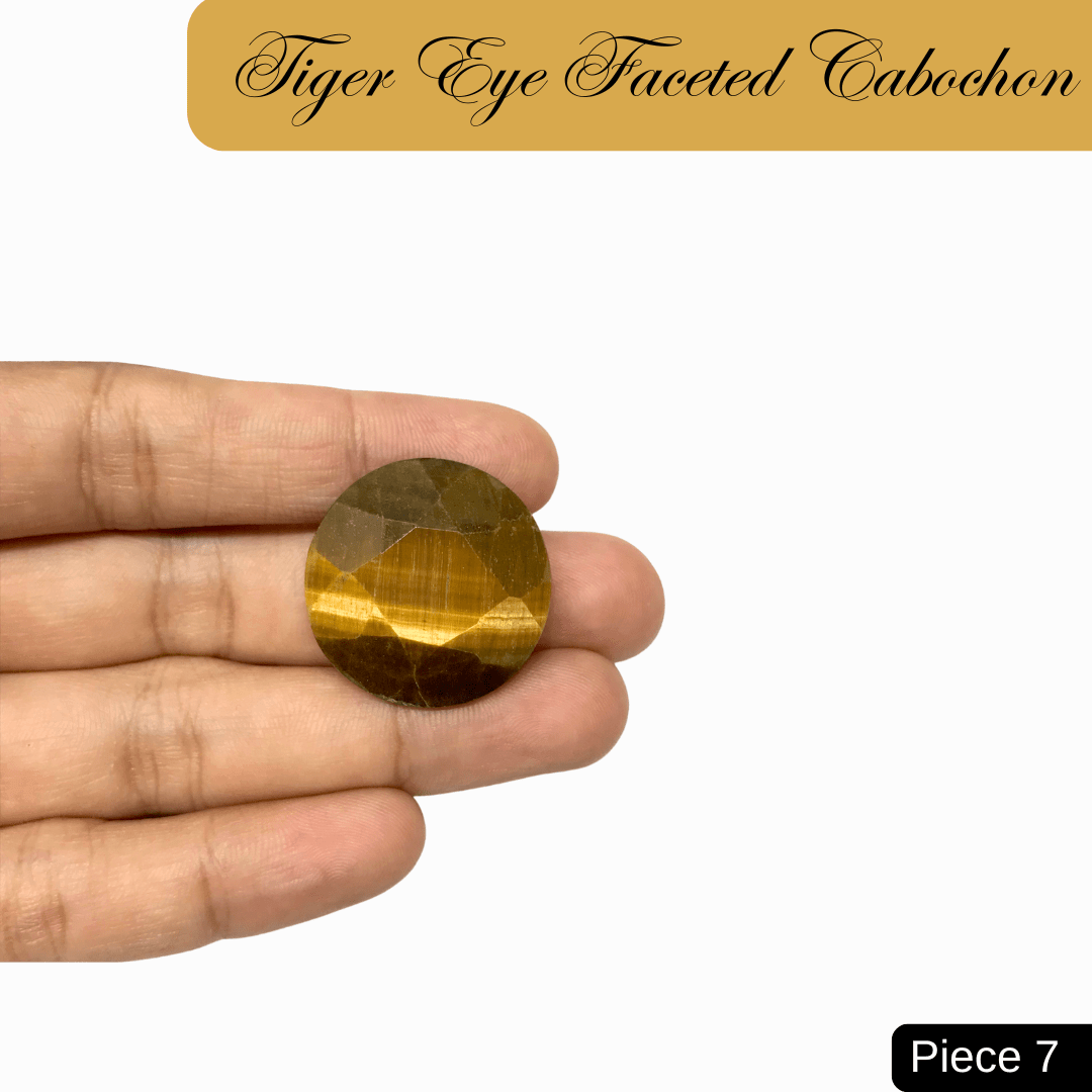 Faceted Tiger Eye cabochon with golden bands showcasing chatoyancy in hand, symbolizing confidence and grounding energy.