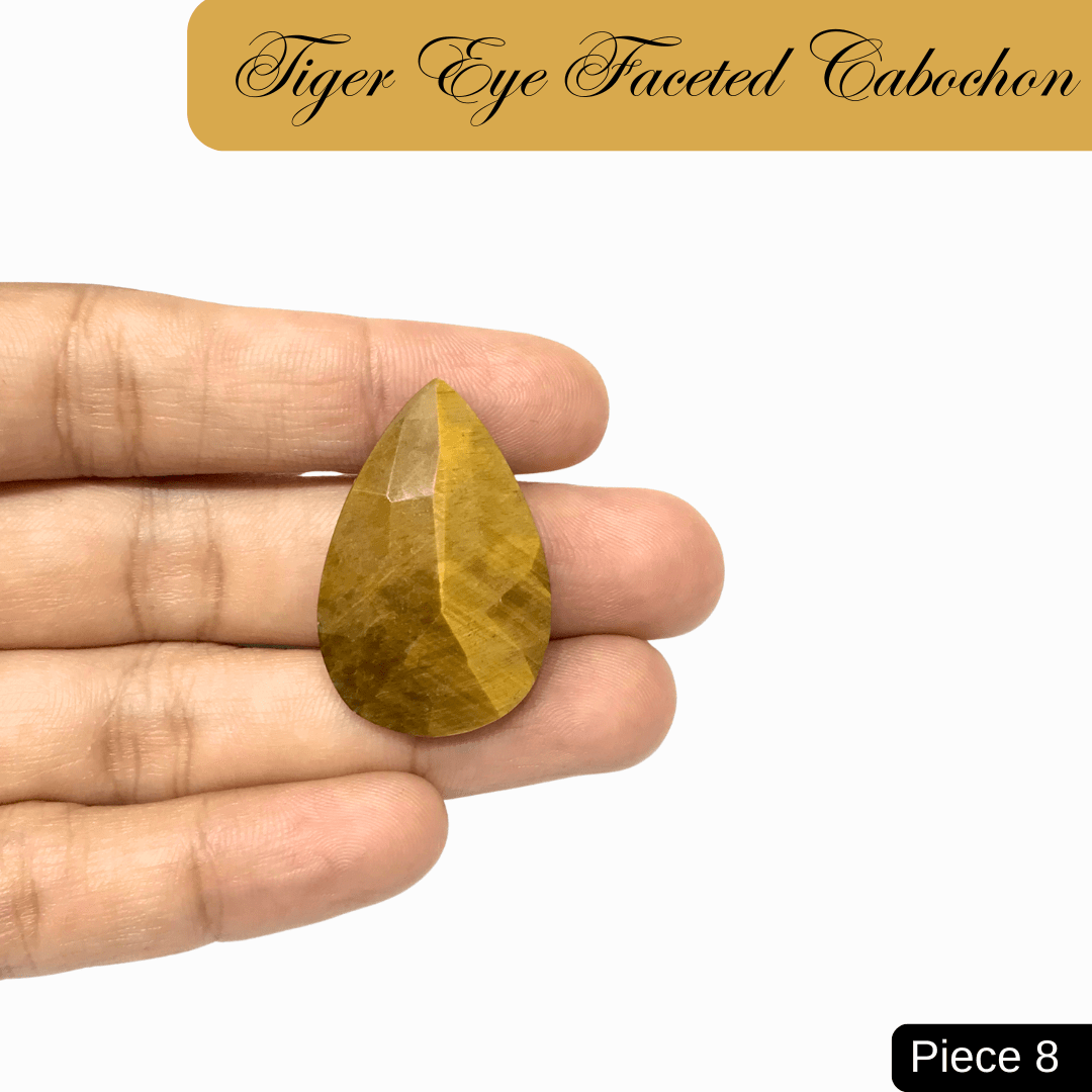 Faceted Tiger Eye cabochon with golden-brown bands, showcasing silky chatoyancy for courage, clarity, and grounding energy.