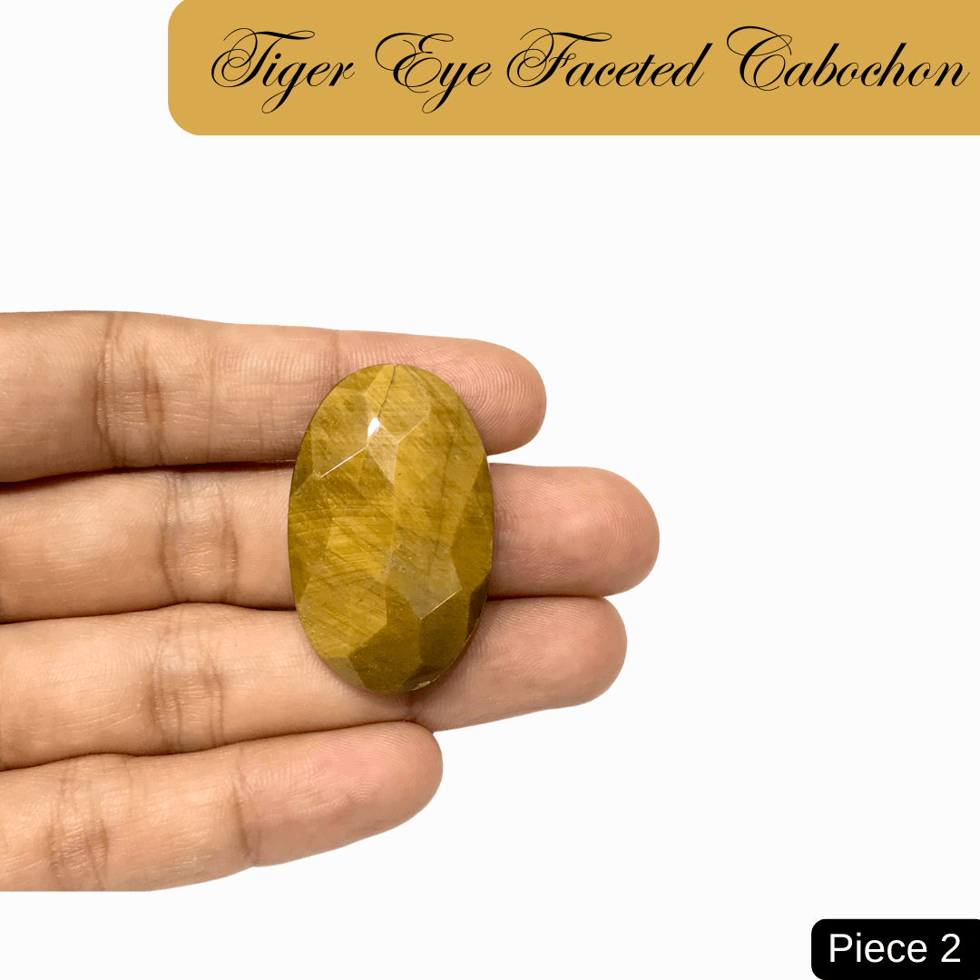Faceted Tiger Eye Cabochon in hand showcasing golden-brown bands and silky chatoyancy for courage and grounding.
