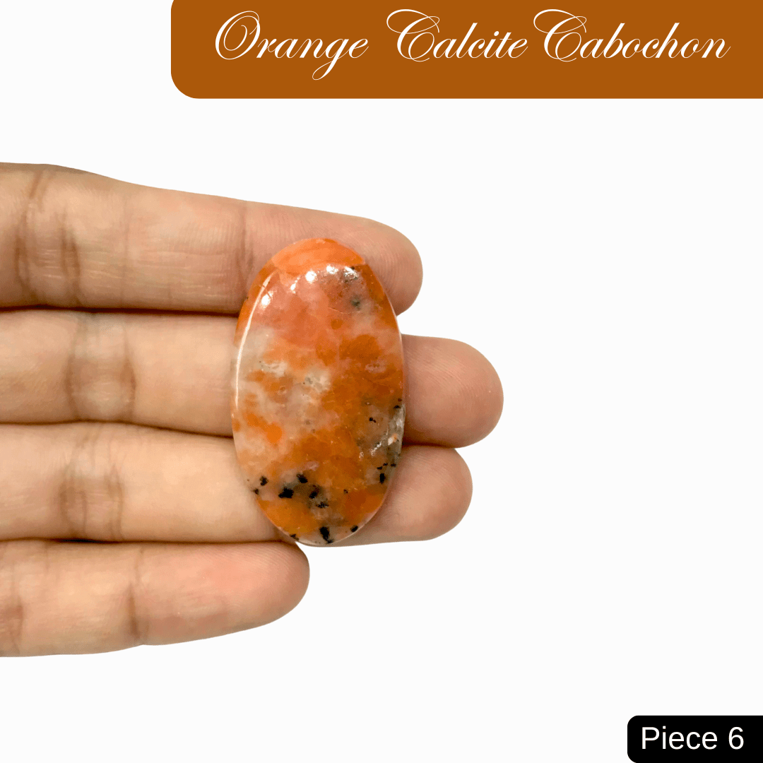 Hand holding orange calcite cabochon, vibrant gemstone for creativity and joy, ideal for healing and emotional vitality.