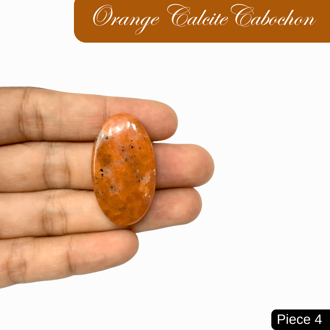 Hand holding vibrant Orange Calcite cabochon, a gemstone known for creativity and inspiration.