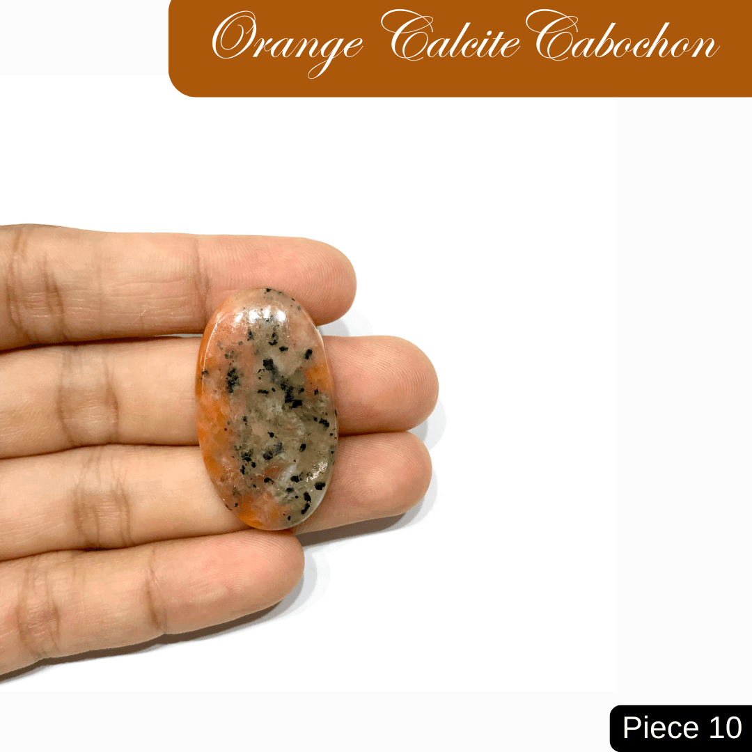 Hand holding an Orange Calcite cabochon with speckled pattern, enhancing creativity and inspiration. Vibrant gemstone piece 10.