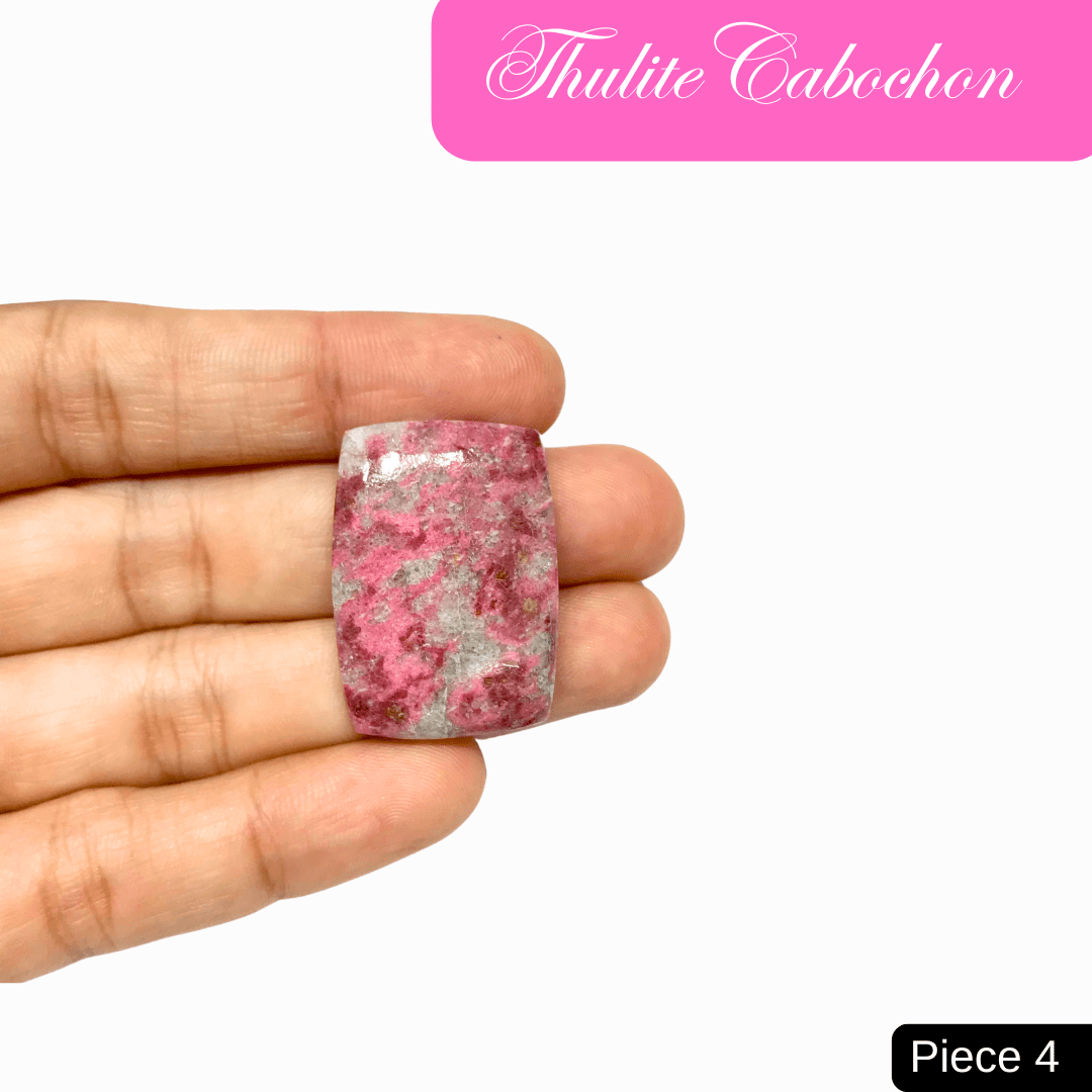 Hand holding a pink thulite cabochon, symbolizing love and emotional healing. Perfect for Heart Chakra and vitality support.