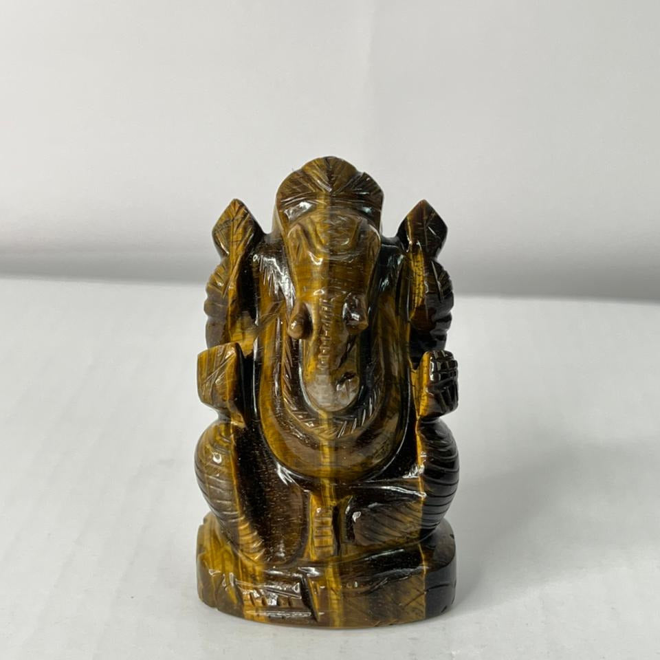 Carved stone figure of Ganesha on a white background