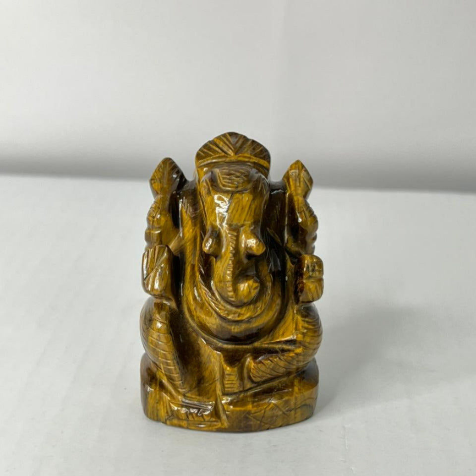 Brown stone statue of a deity on a white background