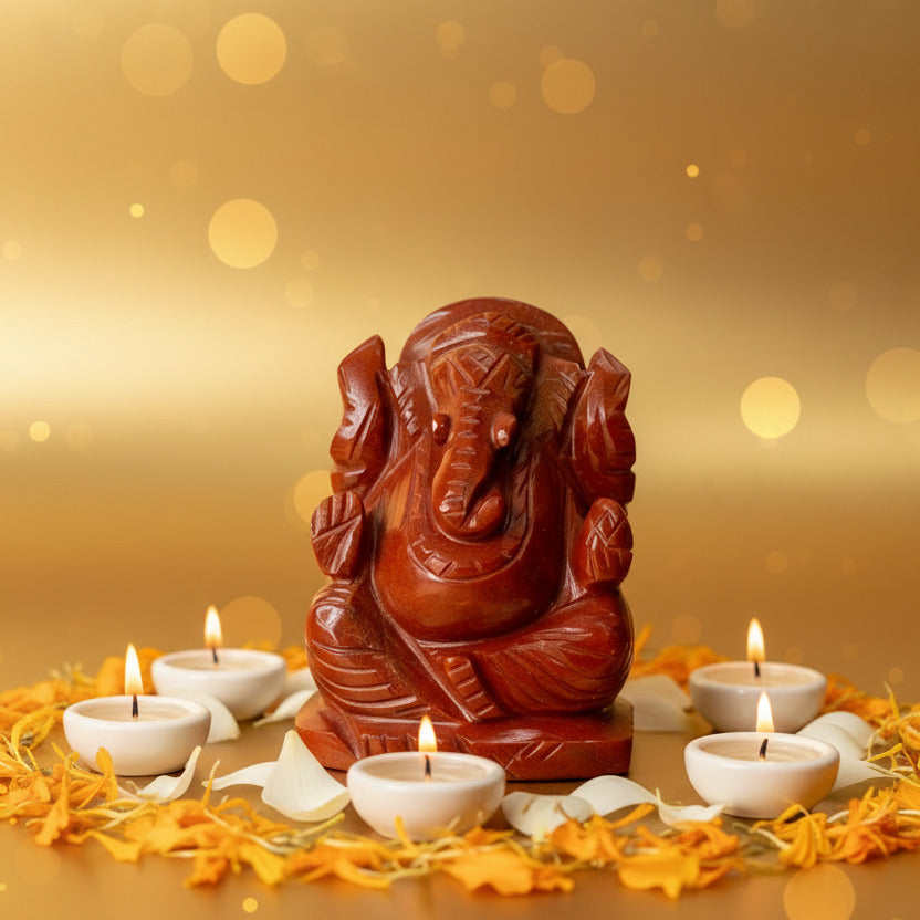 Red stone statue of a deity on a white background