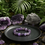 Amethyst bracelet on a black plate with amethyst crystals and rocks in a natural setting