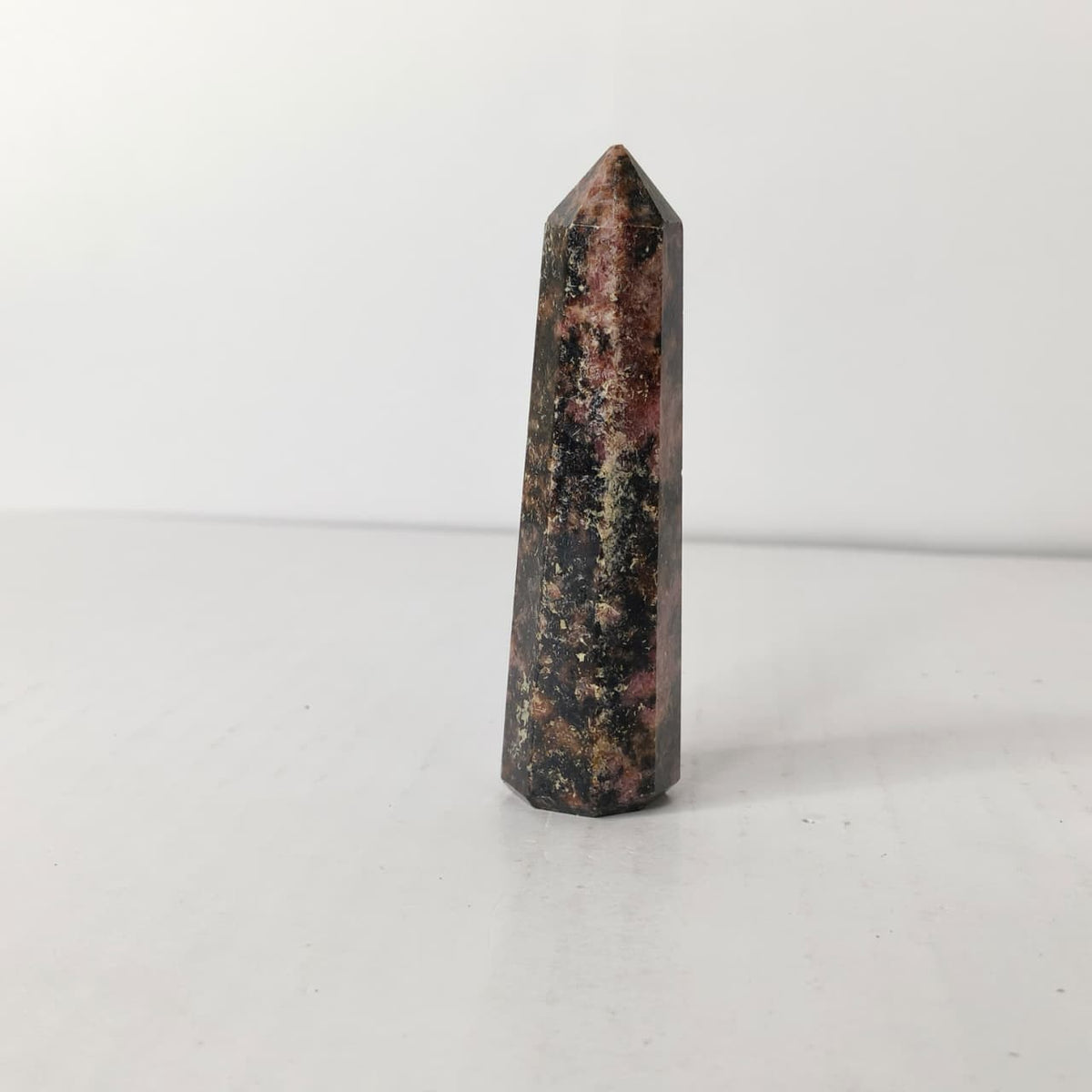 Black and red crystal obelisk on a white background
