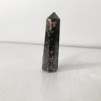 Black and pink crystal tower on a white background