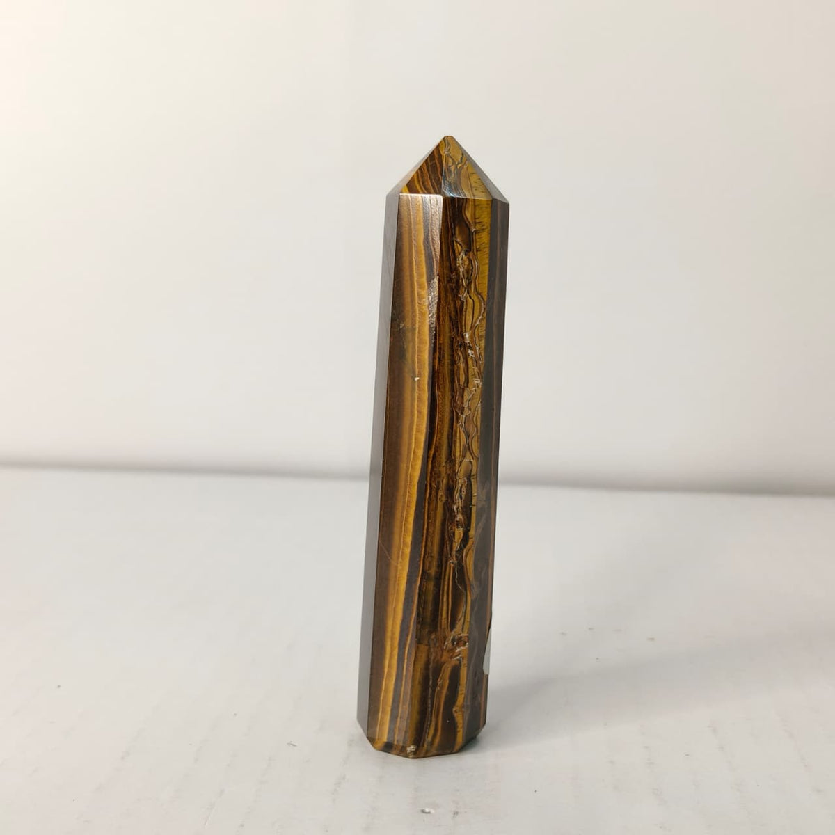 Tiger's eye crystal on a white background