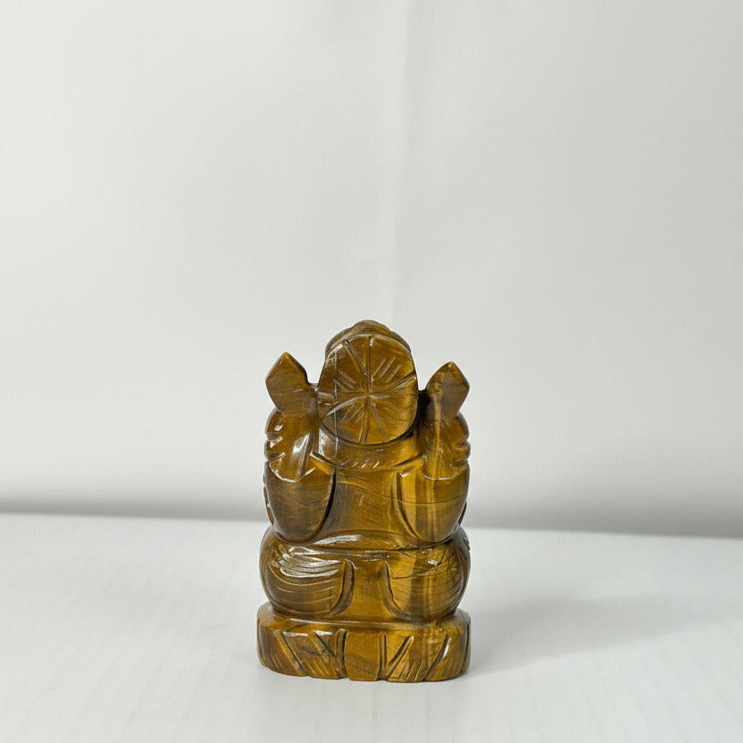 Tiger's eye Ganesha statue on a white background