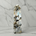 Crystal tower with natural patterns on a plain background