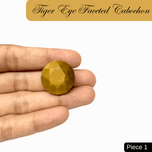 Hand holding faceted Tiger Eye cabochon gemstone, showcasing golden-brown bands and silky chatoyancy for confidence and grounding.