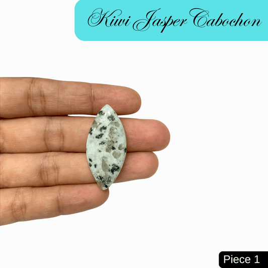 Person holding a green and black speckled Kiwi Jasper cabochon, known for tranquility and emotional strength. Piece 1.
