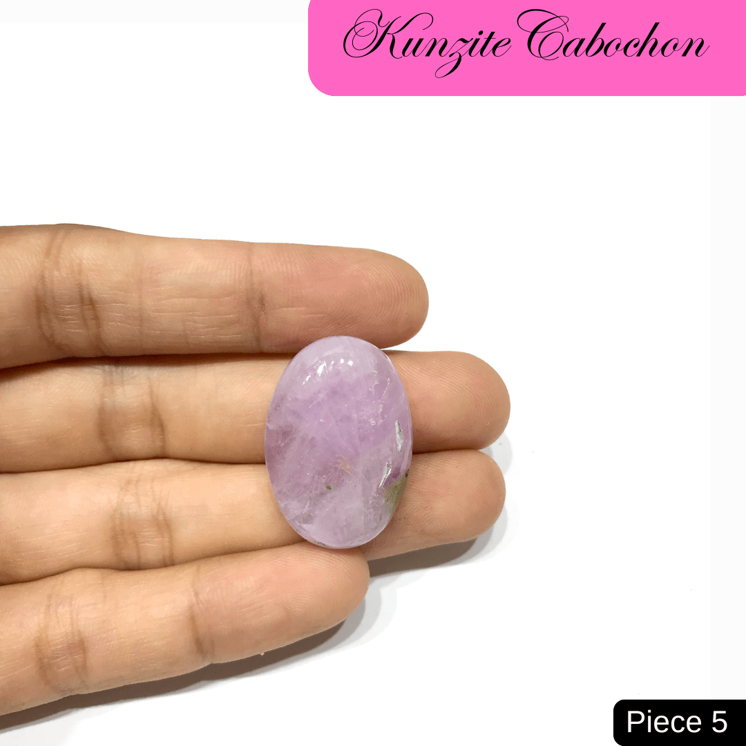 Hand holding a soft pink Kunzite cabochon gemstone, known for its radiant hue and high-vibrational energy, ideal for emotional healing.