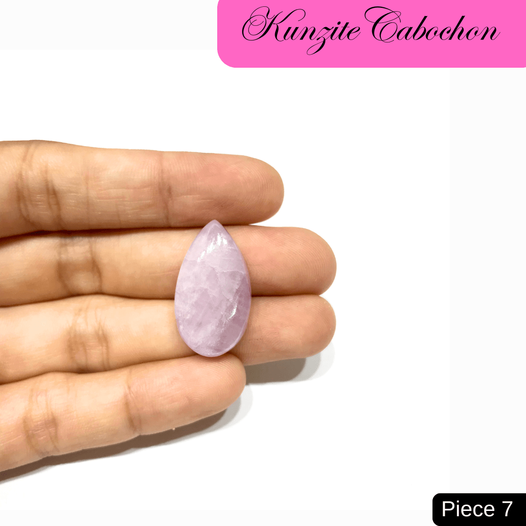Kunzite Cabochon in Hand: Teardrop-shaped pink gemstone showcasing high-vibrational energy and love properties, Piece 7.