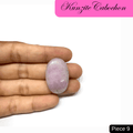 Hand holding a soft pink Kunzite cabochon gemstone, known for its spiritual awakening and healing properties, labeled as piece 9.