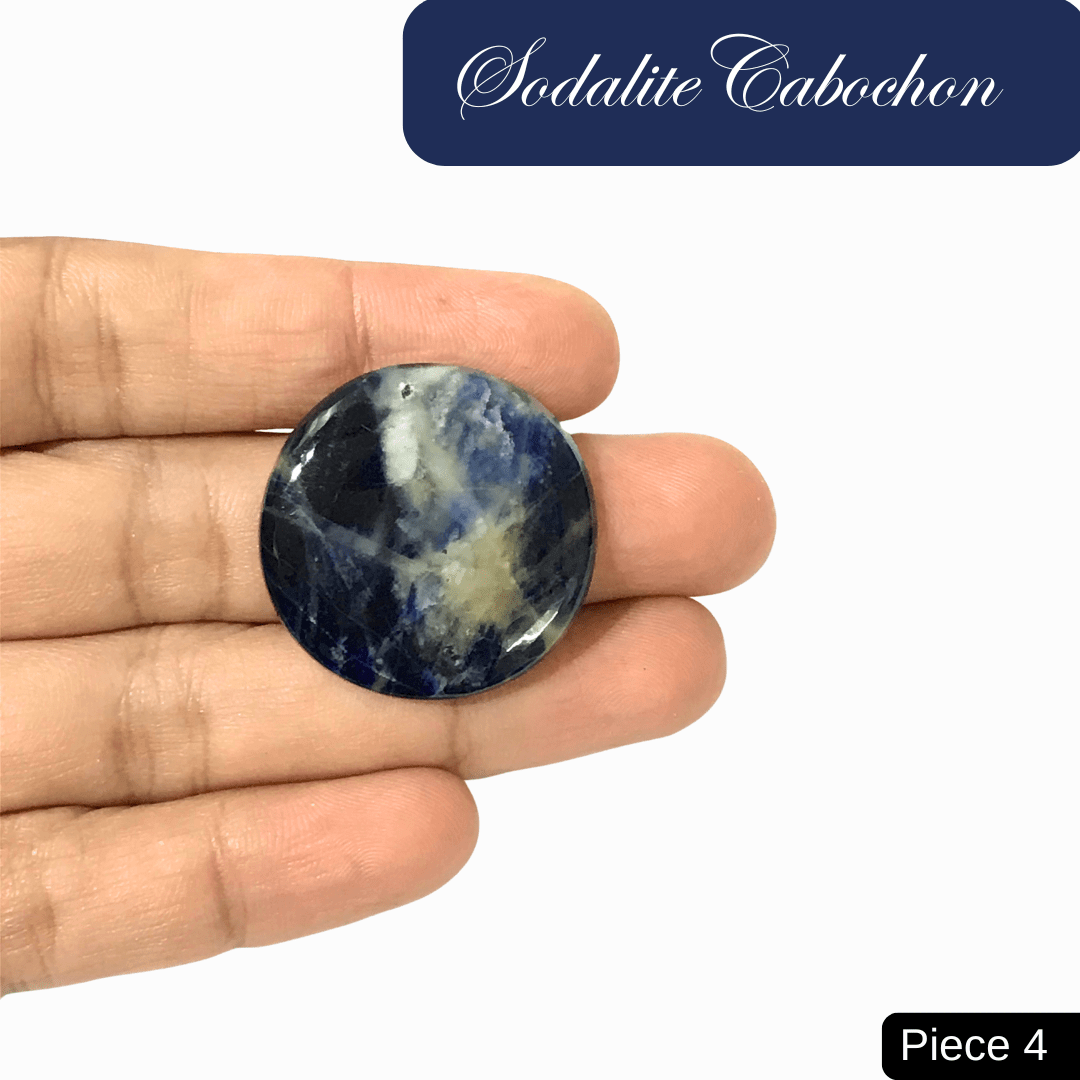 Hand holding a round blue Sodalite cabochon with white calcite veins, showcasing its color and pattern.
