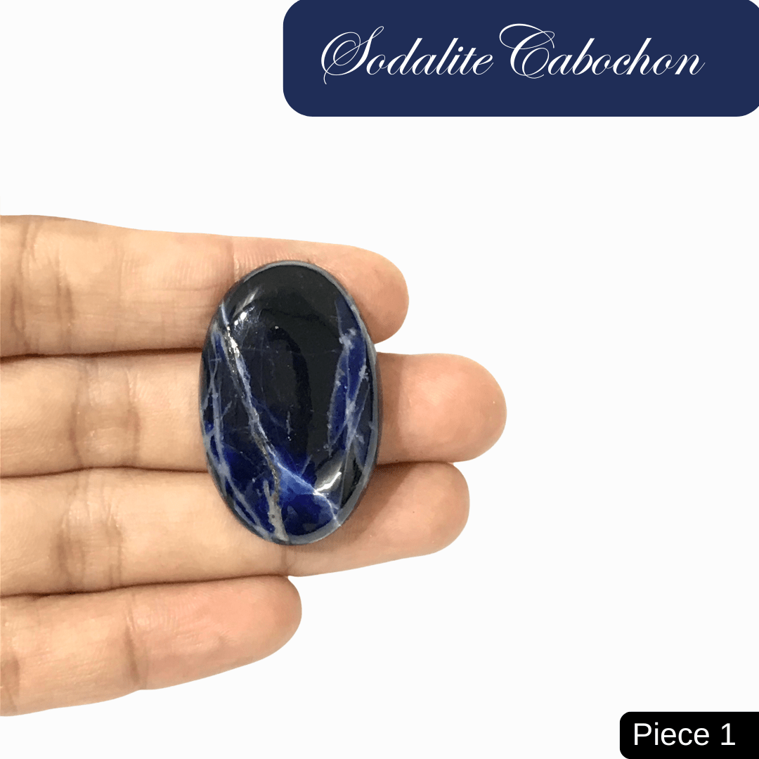 Hand holding a blue sodalite cabochon with white calcite veins for truth and intuition enhancement, labeled Piece 1.