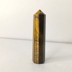 Tiger eye crystal tower on a white background