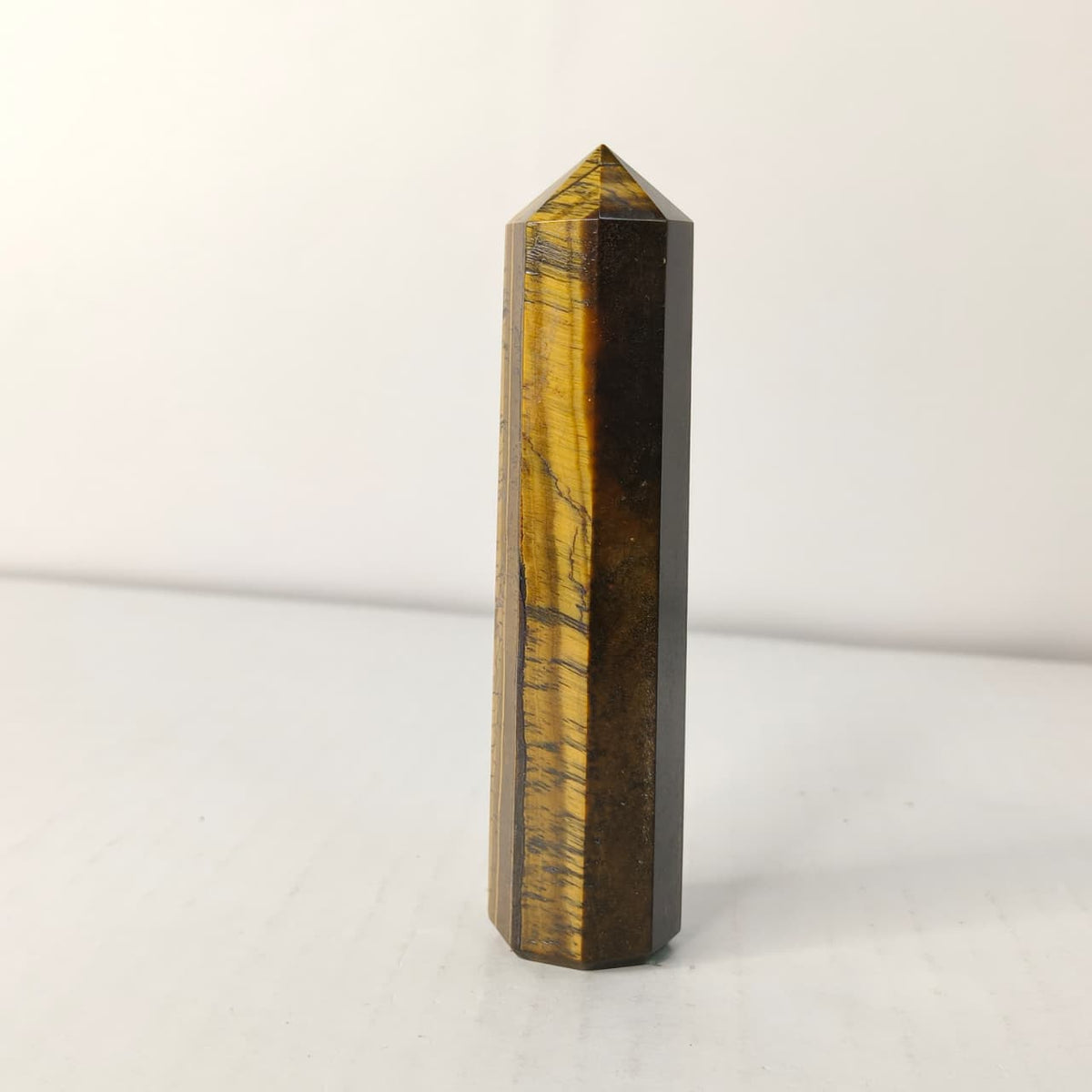 Tiger eye crystal tower on a white background