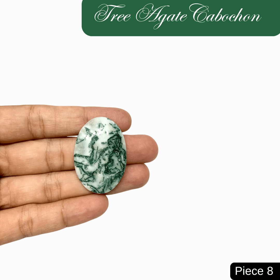 Tree Agate Cabochon with green marbled patterns held in hand, symbolizing inner peace and connection to nature.